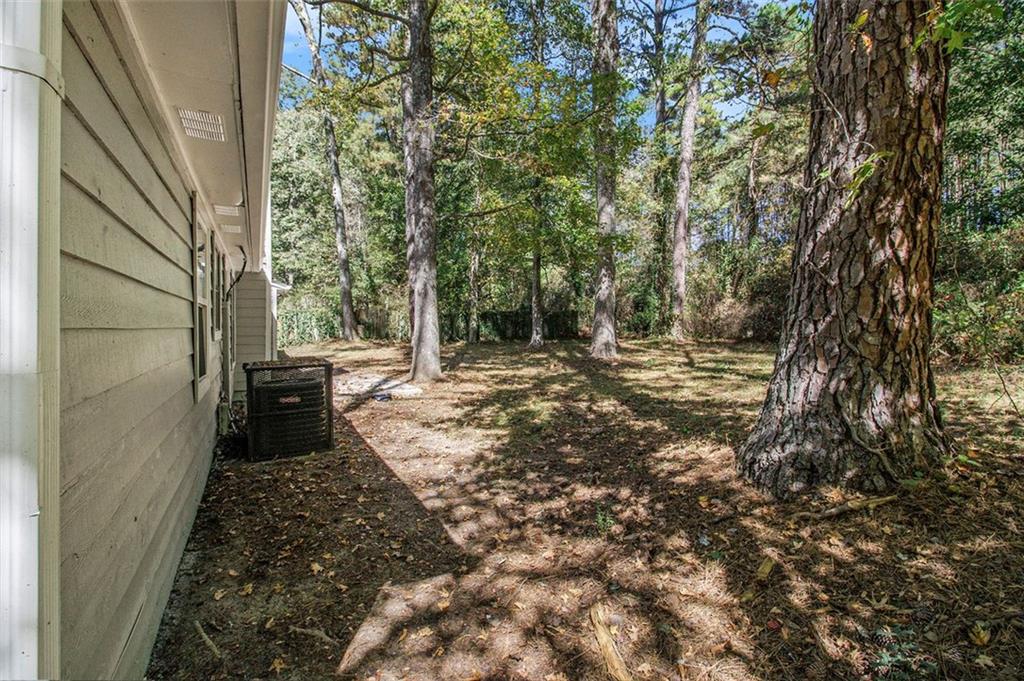 1748 Charmeth Road Lithonia, GA 30058 - Photo 30 of 32 a view of a yard with trees