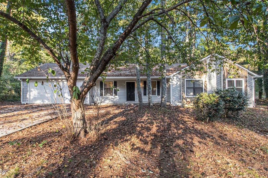 1748 Charmeth Road Lithonia, GA 30058 - Photo 3 of 32 front view of a house with a tree