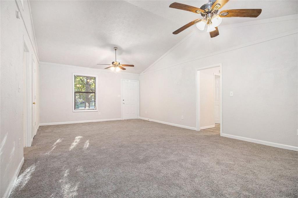 1748 Charmeth Road Lithonia, GA 30058 - Photo 4 of 32 an empty room with windows and fan