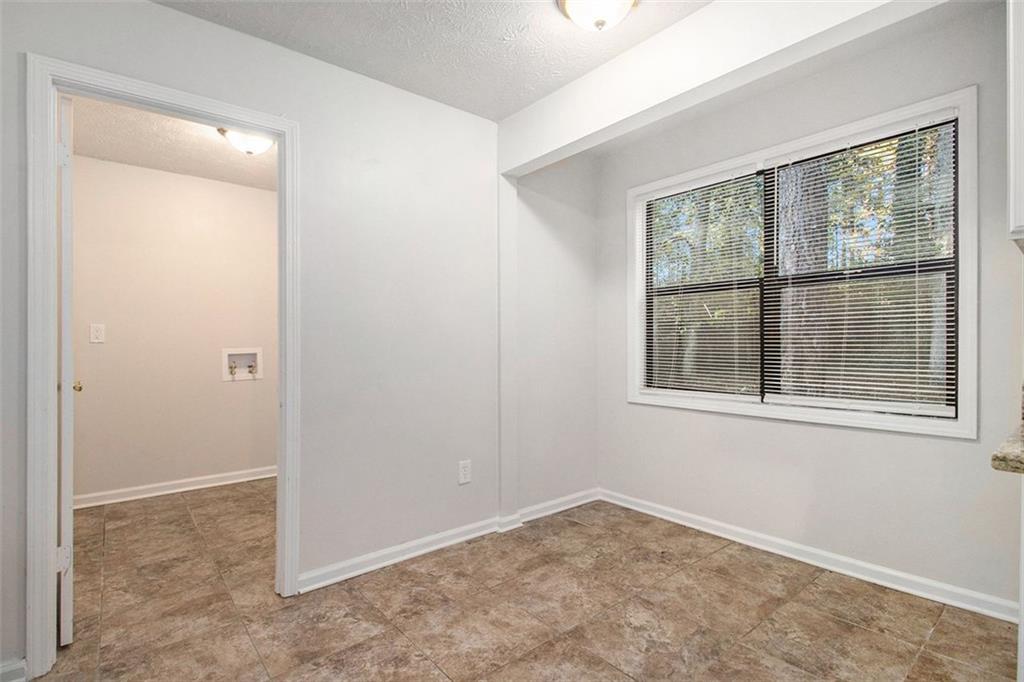1748 Charmeth Road Lithonia, GA 30058 - Photo 7 of 32 an empty room with a window