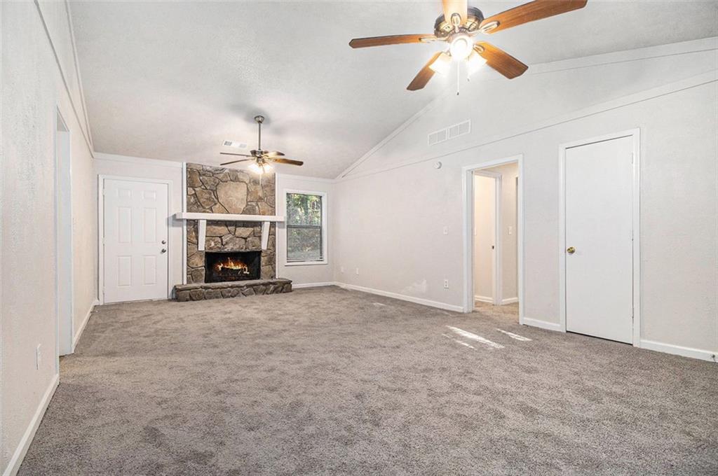1748 Charmeth Road Lithonia, GA 30058 - Photo 8 of 32 an empty room with closet and a ceiling fan