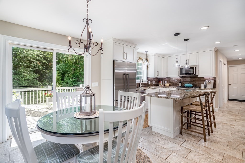 145 Tuckerman Road Ashburnham, MA 01430 - Photo 13 of 42 a dining room with furniture a chandelier and wooden floor