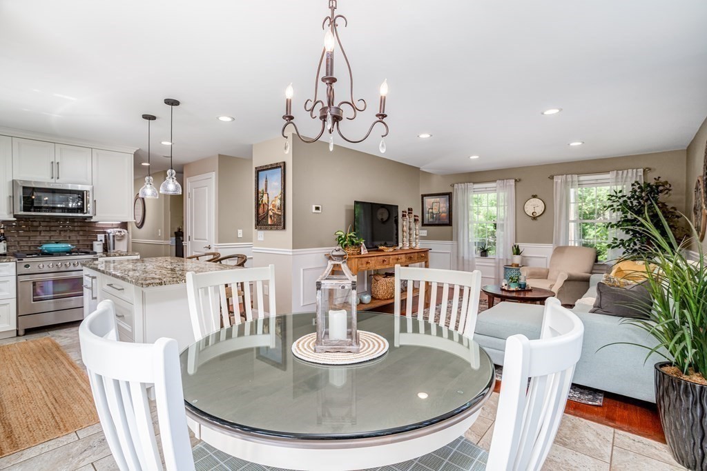 145 Tuckerman Road Ashburnham, MA 01430 - Photo 14 of 42 a dining room with wooden floor a chandelier a wooden table and chairs