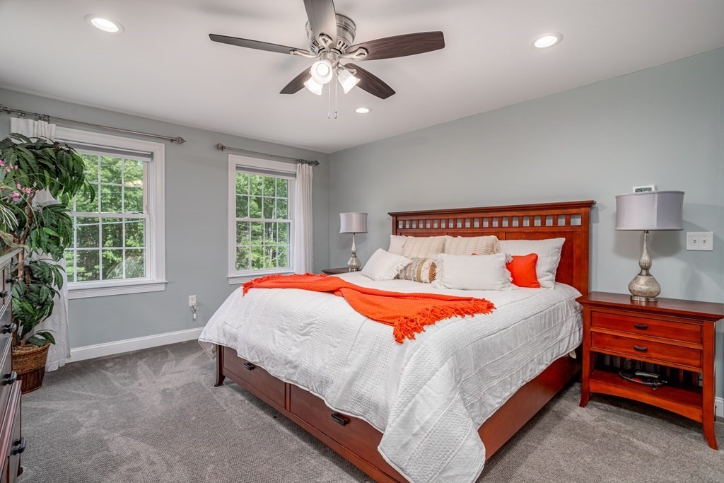 145 Tuckerman Road Ashburnham, MA 01430 - Photo 25 of 42 a bedroom with a large bed and a chandelier fan