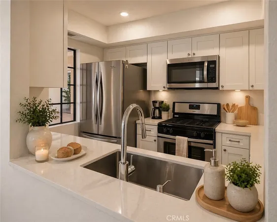 a kitchen with granite countertop a sink and a stove top oven with wooden floor