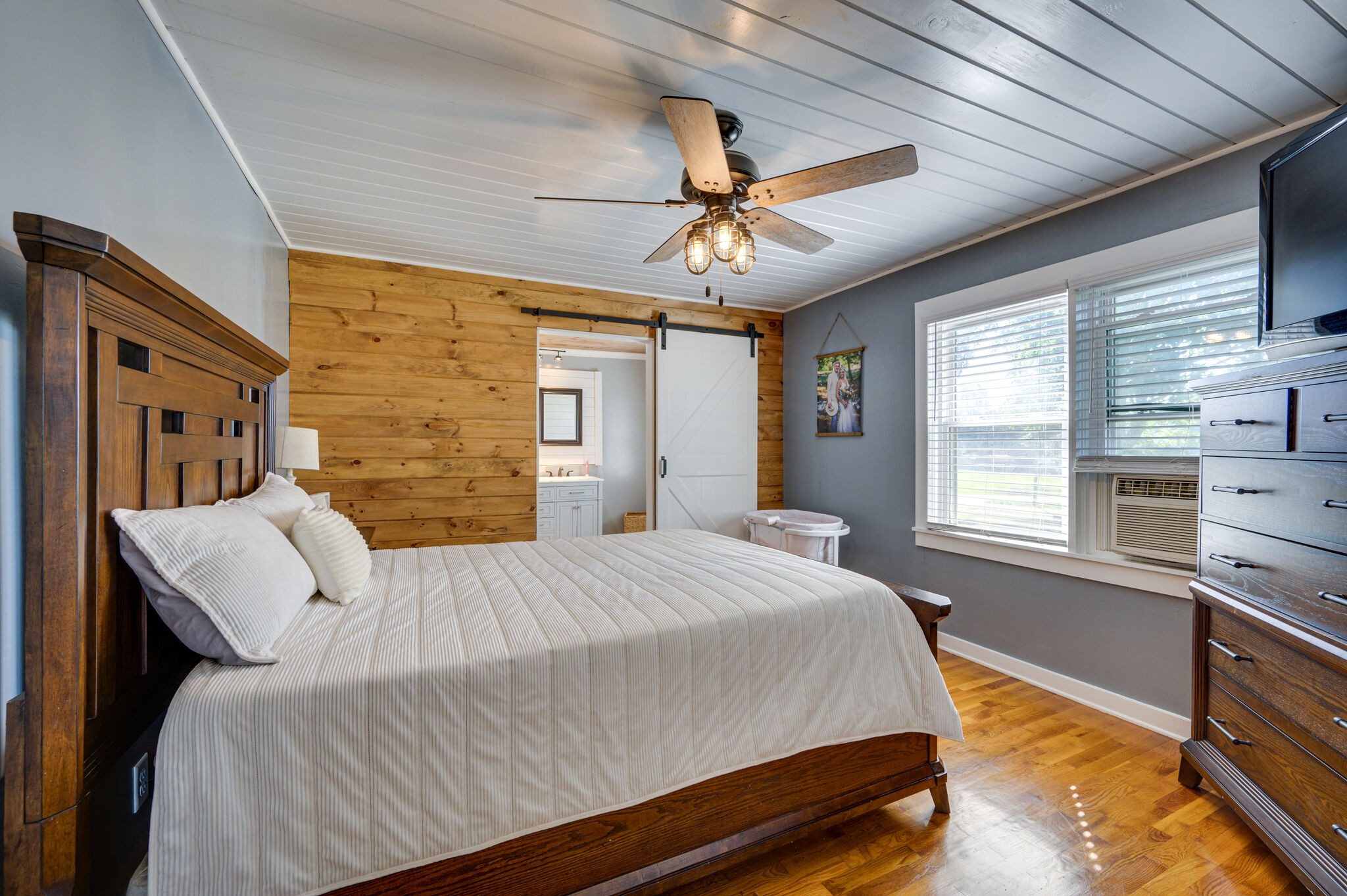 2558 Chisholm Road Iron City, TN 38463 - Photo 14 of 35 a bedroom with a bed next to a window with a chandelier