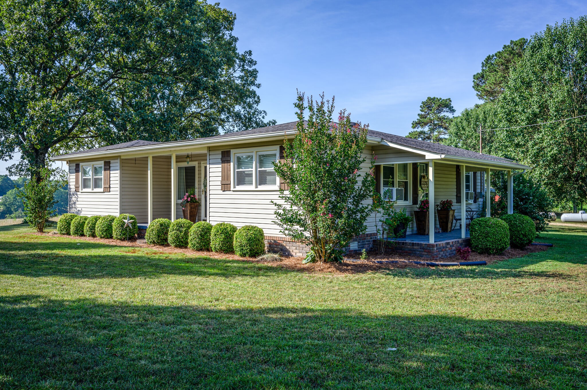 2558 Chisholm Road Iron City, TN 38463 - Photo 3 of 35 a front view of a house with a yard and potted plants
