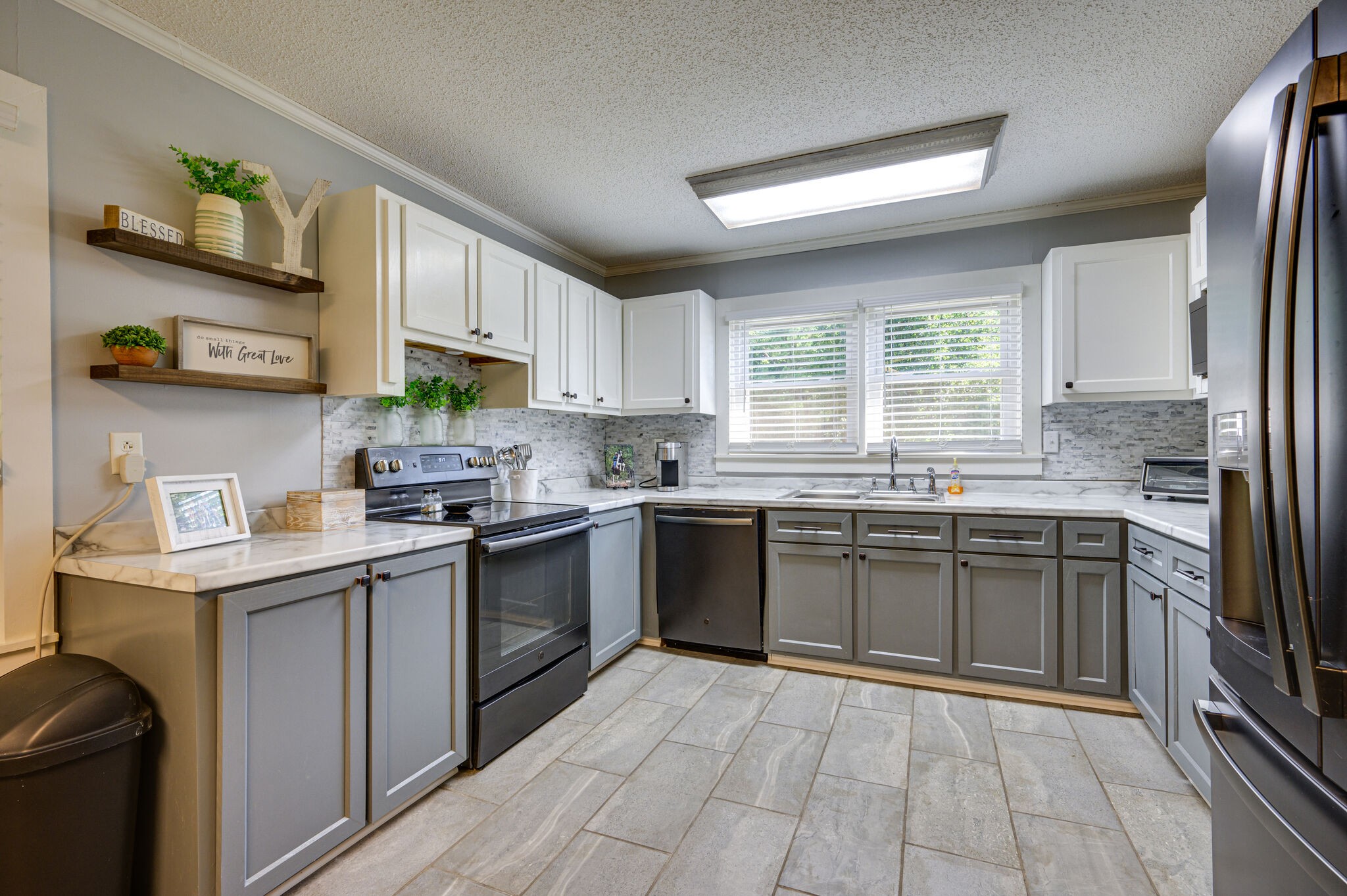 2558 Chisholm Road Iron City, TN 38463 - Photo 9 of 35 a kitchen with stainless steel appliances granite countertop a sink a stove a refrigerator cabinets and a window