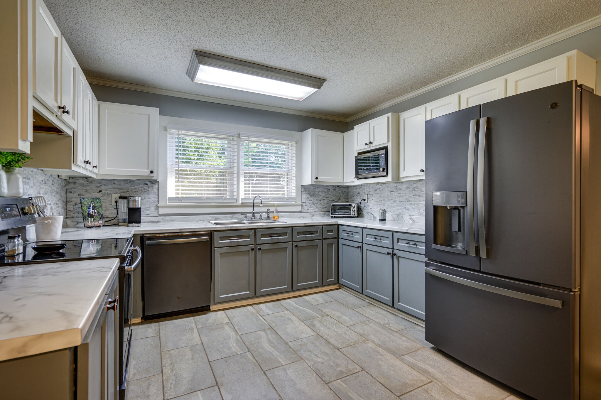 2558 Chisholm Road Iron City, TN 38463 - Photo 10 of 35 a kitchen with granite countertop stainless steel appliances cabinets a sink and a window
