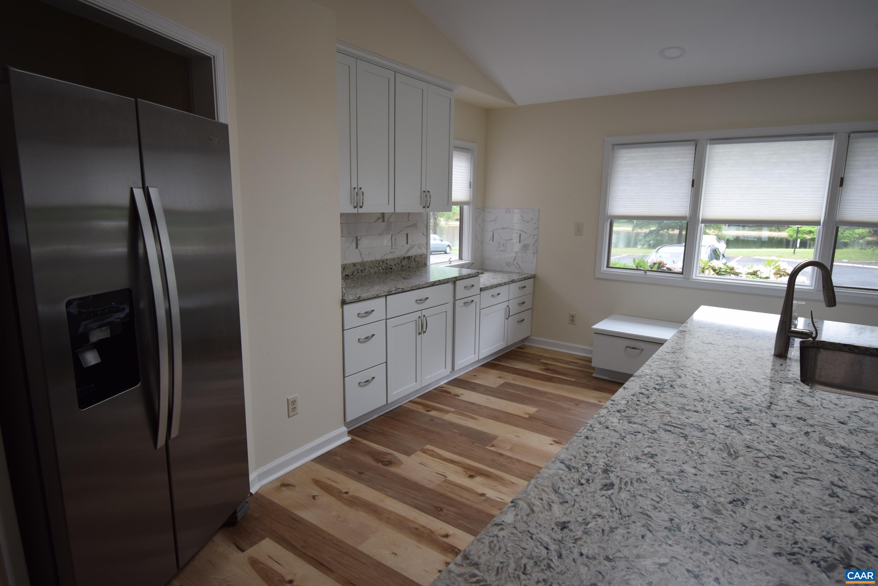 B3 Marina Point Palmyra, VA 22963 - Photo 5 of 31 a kitchen with stainless steel appliances granite countertop a refrigerator a sink and white cabinets