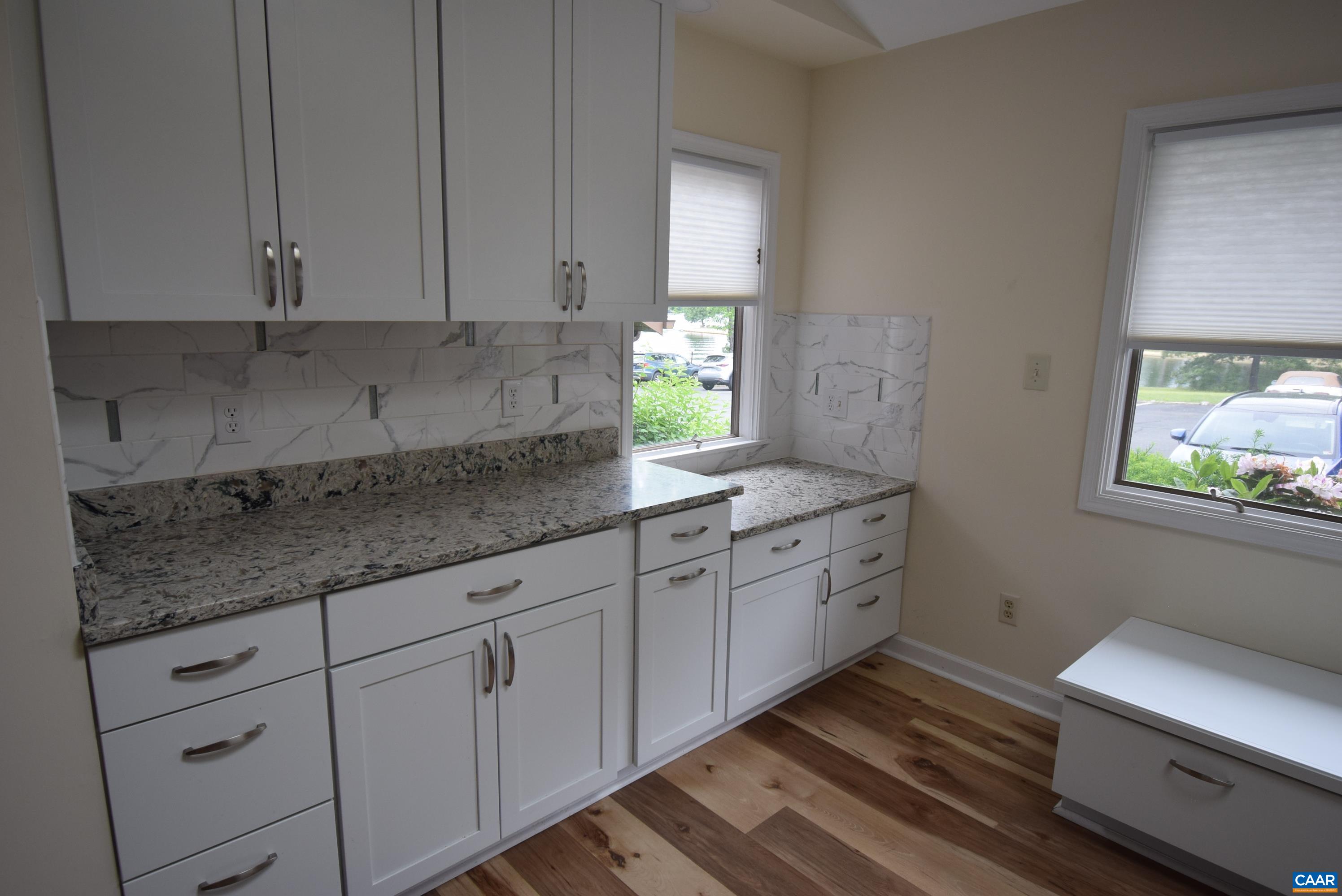 B3 Marina Point Palmyra, VA 22963 - Photo 7 of 31 a kitchen with granite countertop white cabinets and white stainless steel appliances