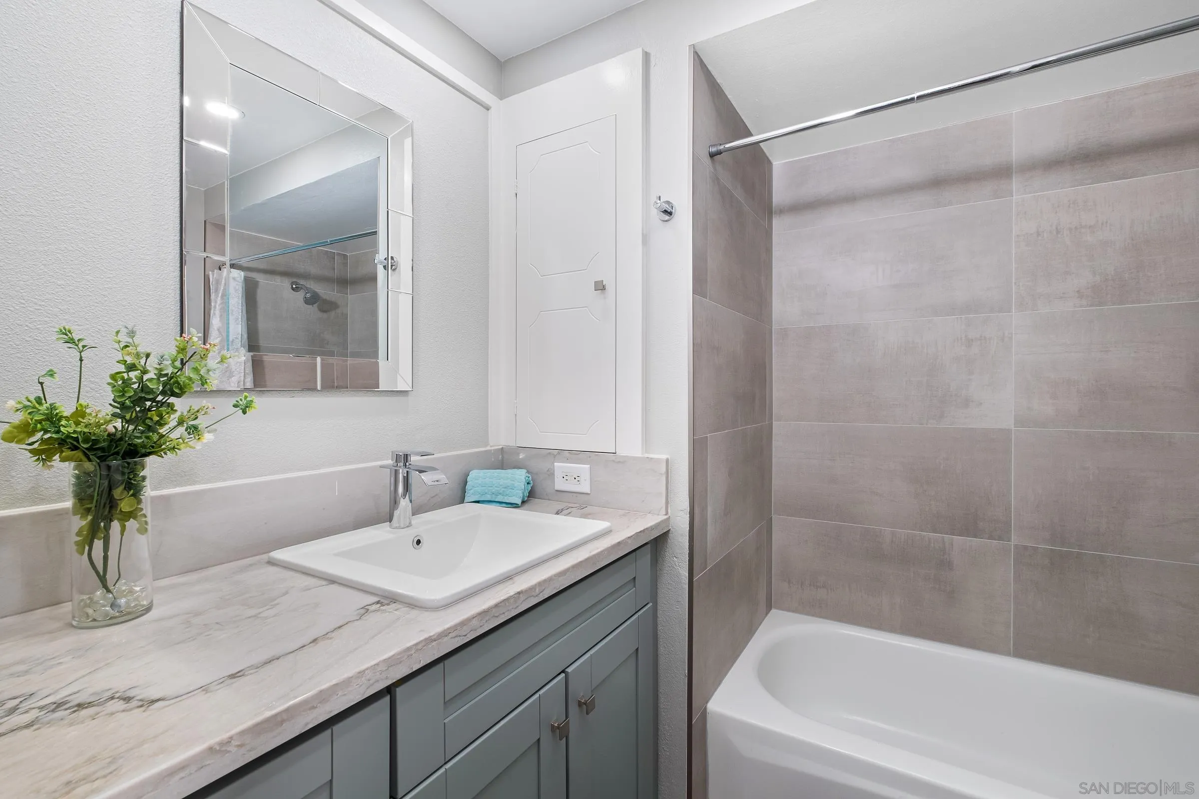 12176 Rancho Bernardo Road, Unit B San Diego, CA 92128 - Photo 14 of 41 a bathroom with a granite countertop sink a mirror a vanity and a bathtub