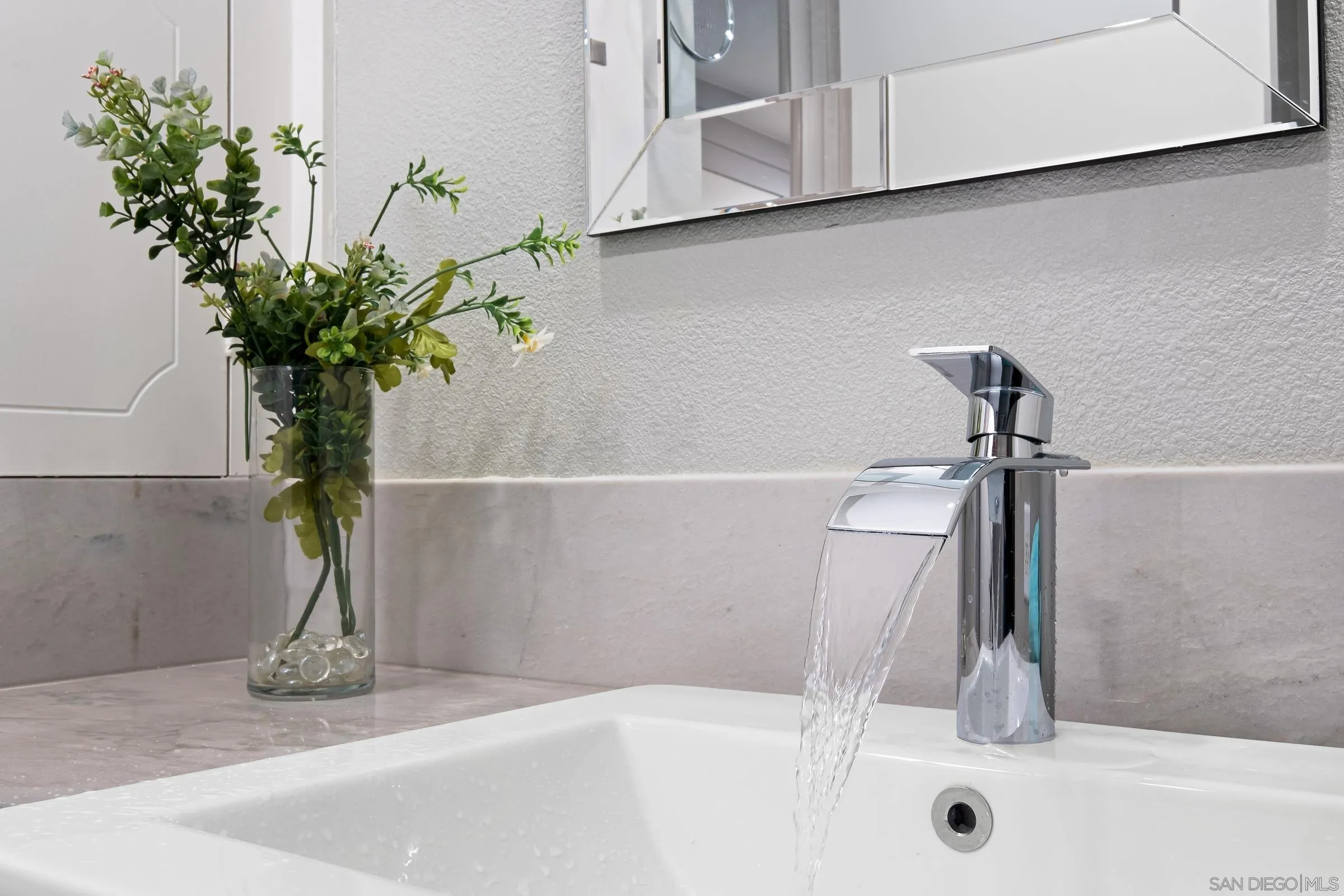 12176 Rancho Bernardo Road, Unit B San Diego, CA 92128 - Photo 15 of 41 a bathroom with a sink a faucet a potted plant and a glass of shower