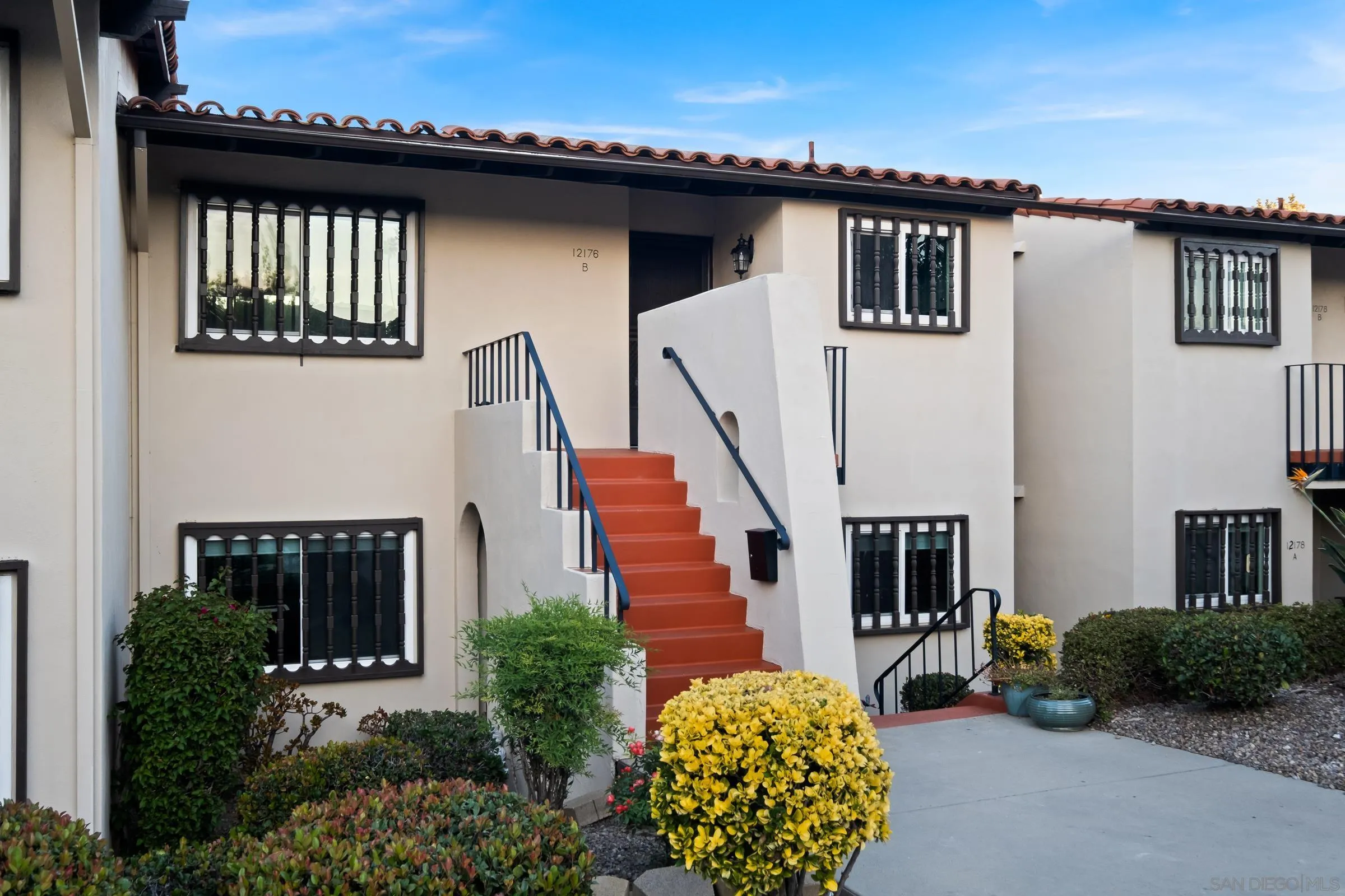 12176 Rancho Bernardo Road, Unit B San Diego, CA 92128 - Photo 4 of 41 a front view of a house with a garden