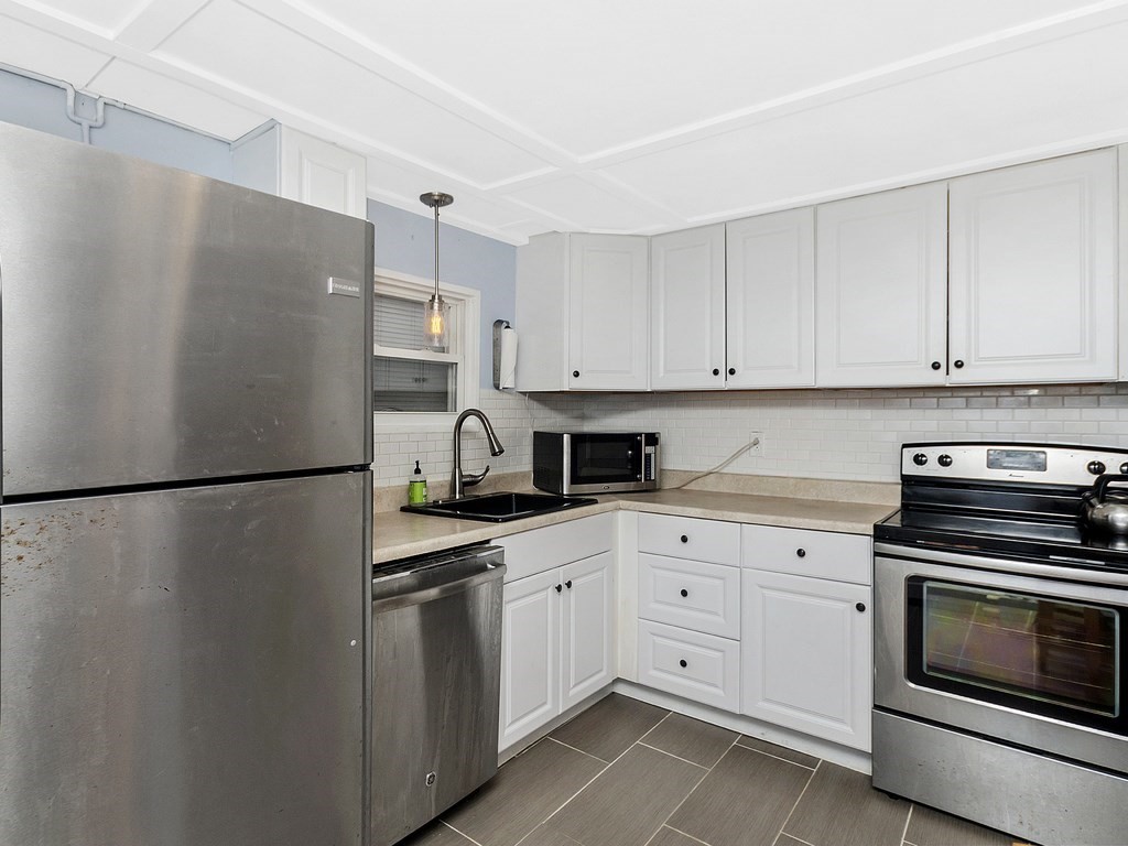 a white refrigerator freezer sitting inside of a kitchen