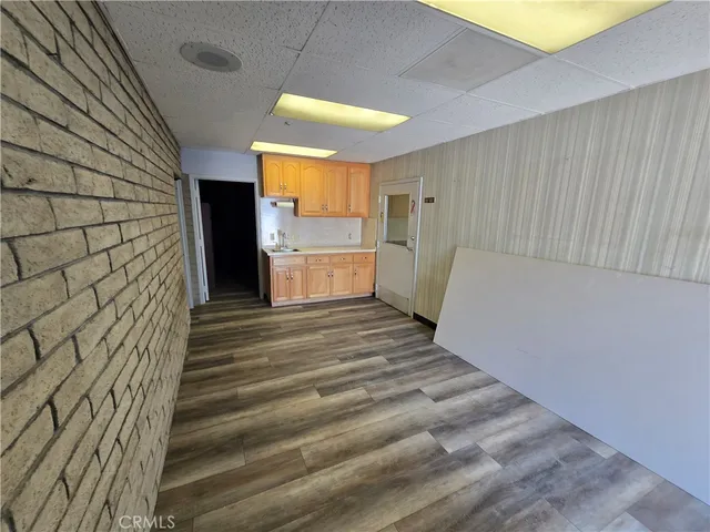 a view of a room with wooden floor and staircase