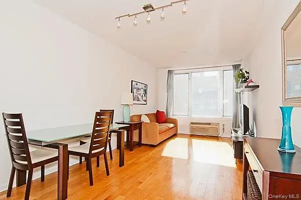 a dining room with furniture and a floor to ceiling window