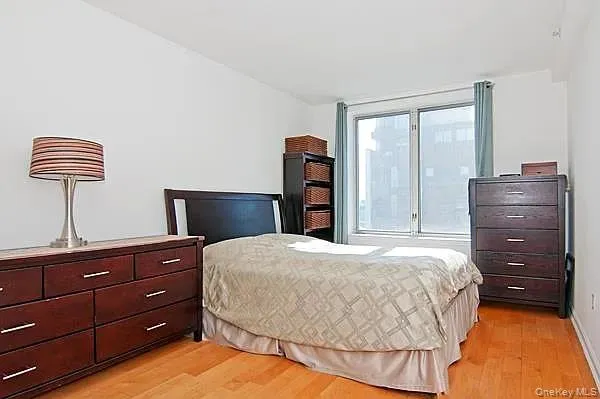 a bedroom with a bed and a lamp