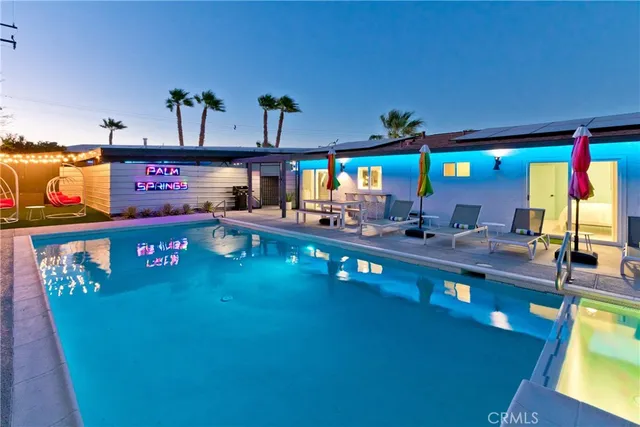 a view of a swimming pool and outdoor seating
