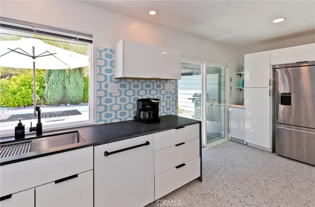 a bedroom with a bed and painting on the wall