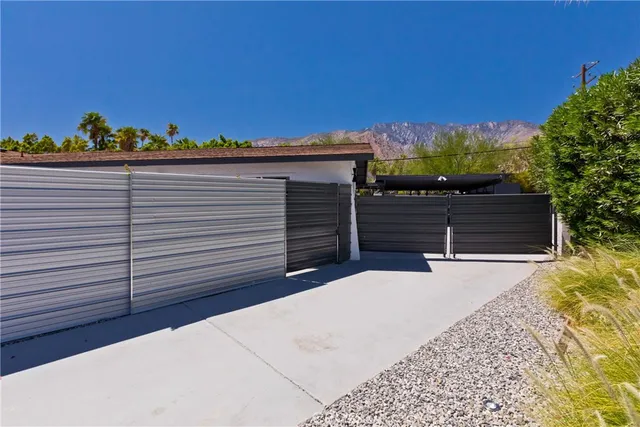 a backyard of a house with table and chairs