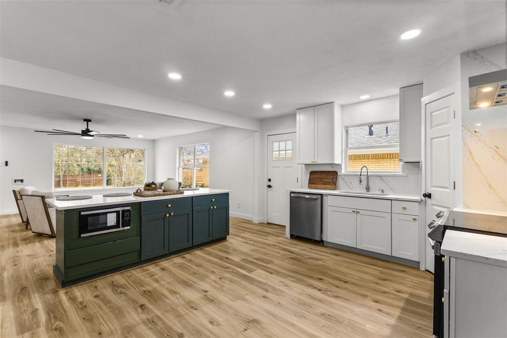 1917 South Vernon Avenue Dallas, TX 75224 - Photo 10 of 28 Open-concept kitchen featuring an expansive two-tone island with a built-in microwave and ample storage