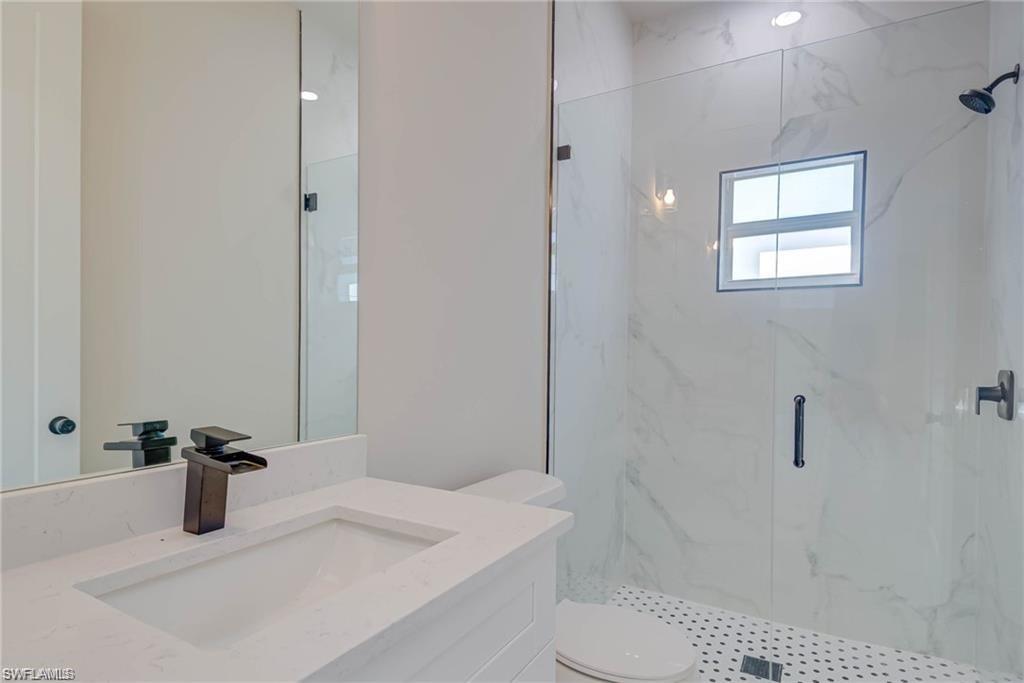 2023 Robert Avenue Alva, FL 33920 - Photo 5 of 8 Full bath featuring a marble finish shower and vanity