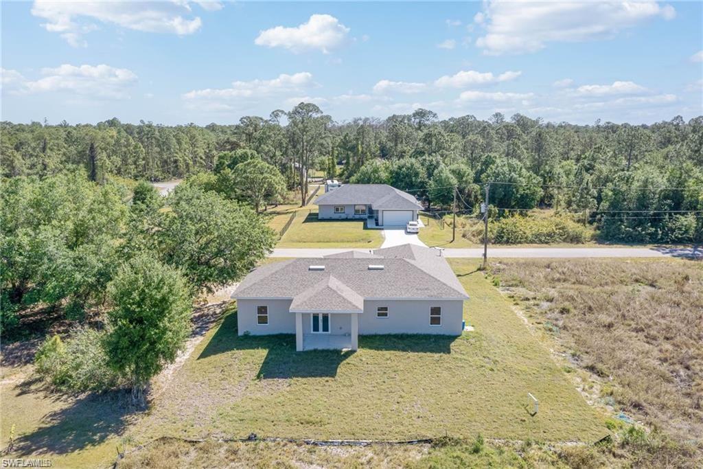 2023 Robert Avenue Alva, FL 33920 - Photo 8 of 8 Aerial view of property and surrounding area with a forest