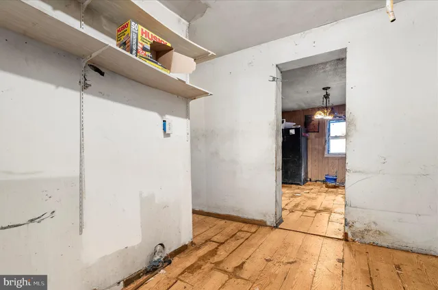 a view of hallway with wooden floor