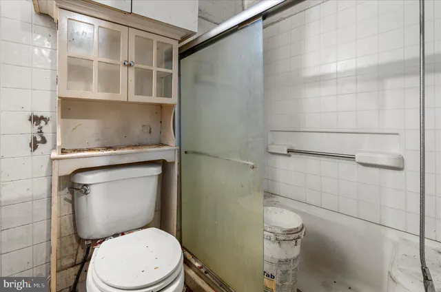 a white toilet sitting next to a bathroom sink