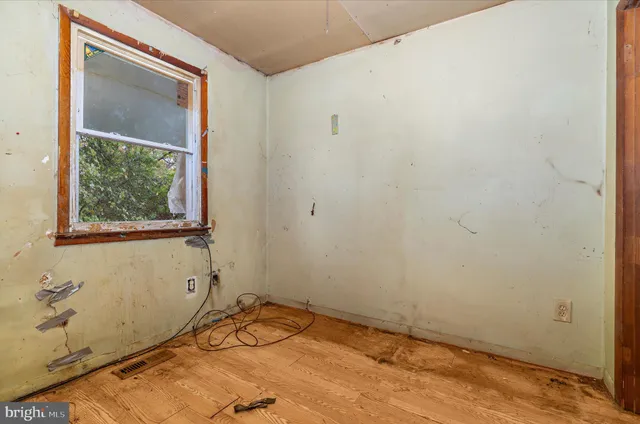 a view of a room with rack on the wall and a window