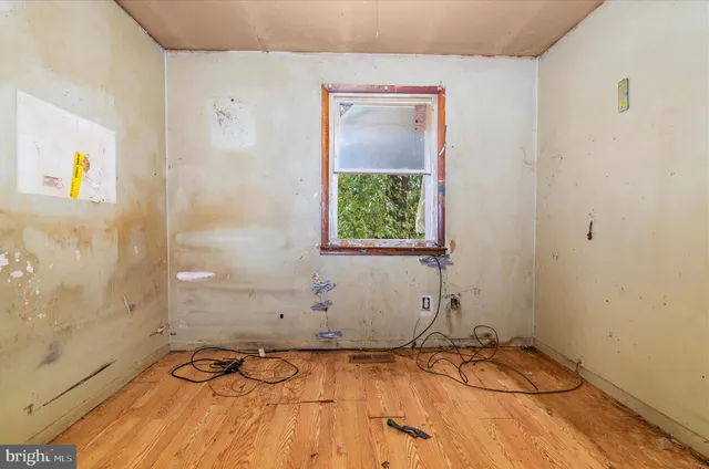 a view of a room with rack on the wall and a window
