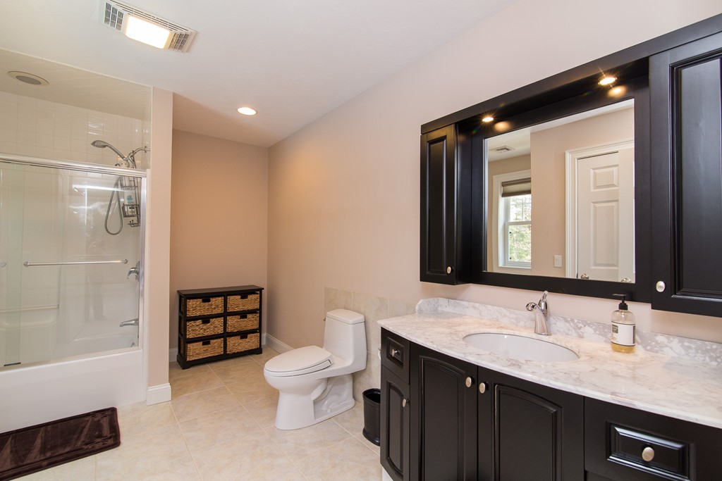 53 Burntmeadow Road Groton, MA 01450 - Photo 20 of 29 a bathroom with a double vanity sink toilet mirror and shower