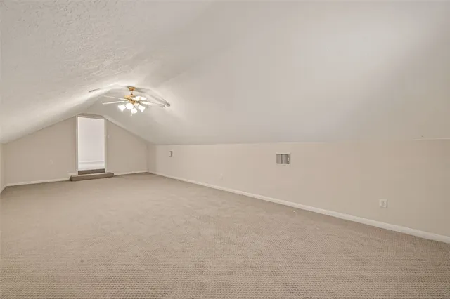 a view of a brick house with many windows