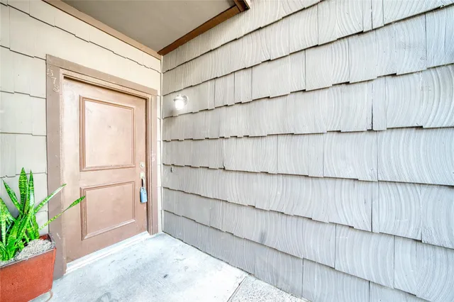 a view of an empty room and wooden floor