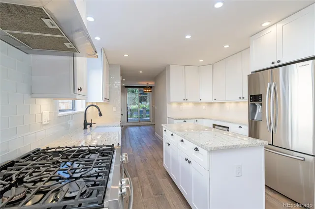 a kitchen with a white stove top oven and refrigerator