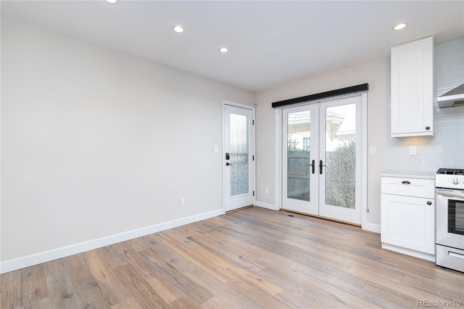 541 Monroe Street, Unit A Denver, CO 80206 - Photo 18 of 45 a view of a big room with wooden floor and windows