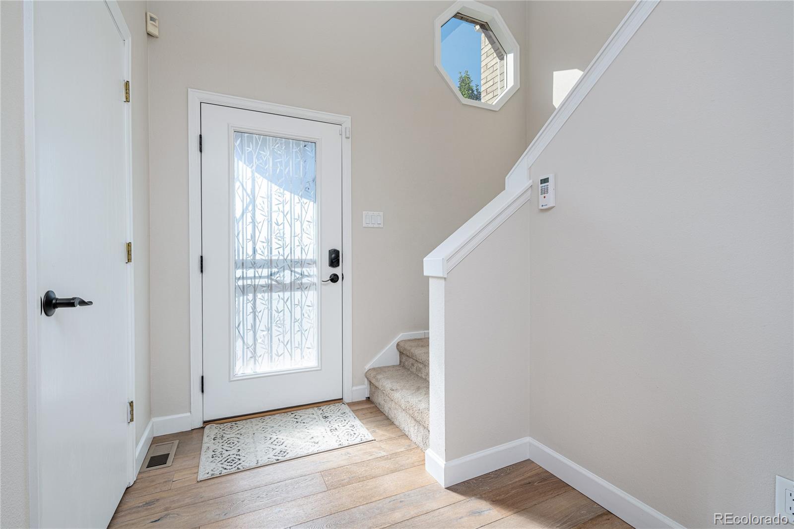541 Monroe Street, Unit A Denver, CO 80206 - Photo 2 of 45 a view of an empty room with wooden floor and a window