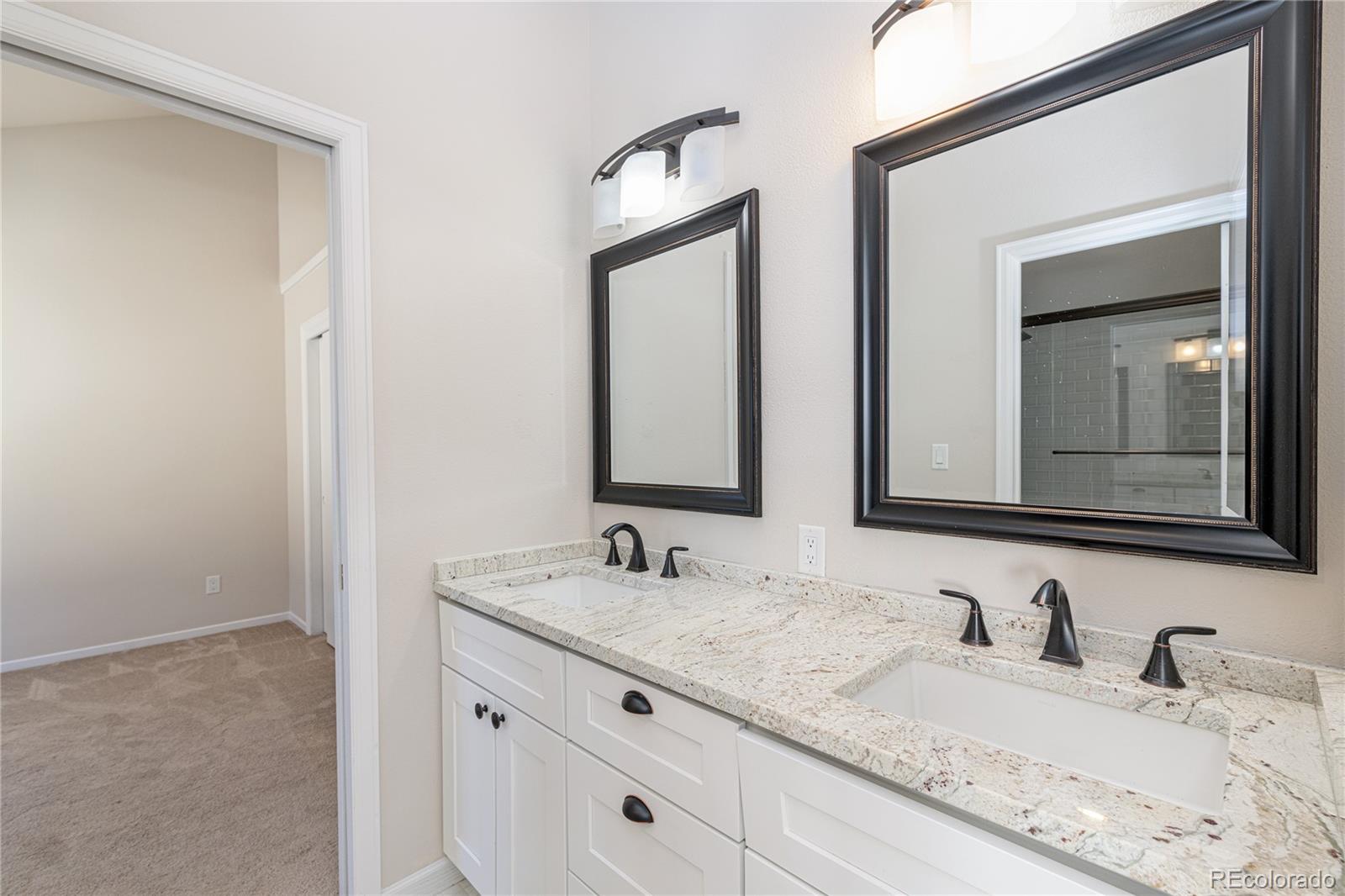 541 Monroe Street, Unit A Denver, CO 80206 - Photo 22 of 45 a bathroom with double sink and a mirror