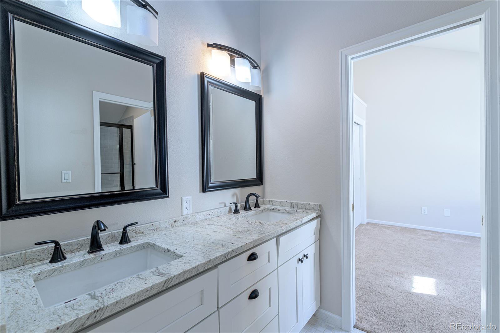 541 Monroe Street, Unit A Denver, CO 80206 - Photo 23 of 45 a bathroom with double sink and a mirror