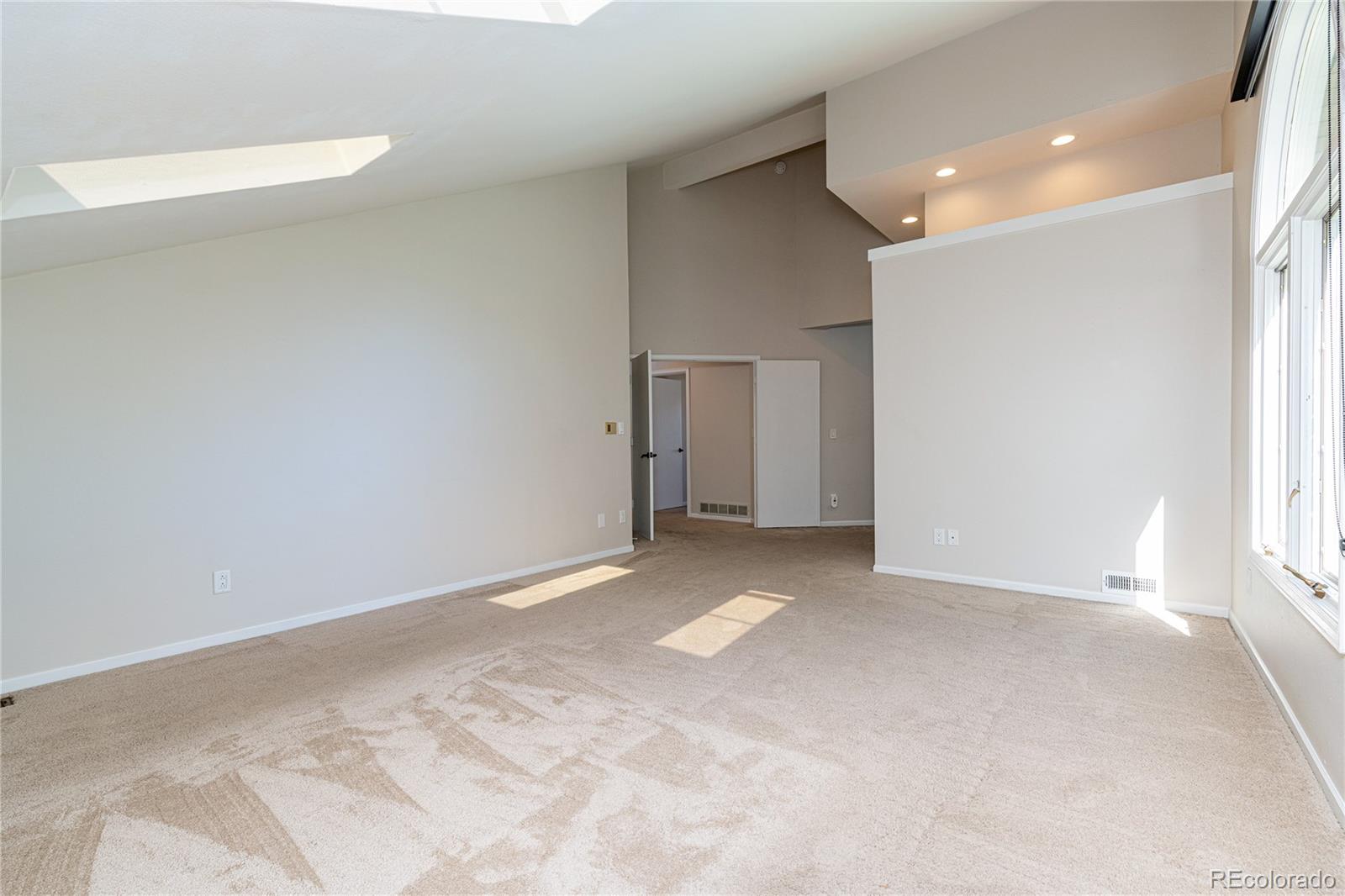 541 Monroe Street, Unit A Denver, CO 80206 - Photo 28 of 45 a view of an empty room with a window