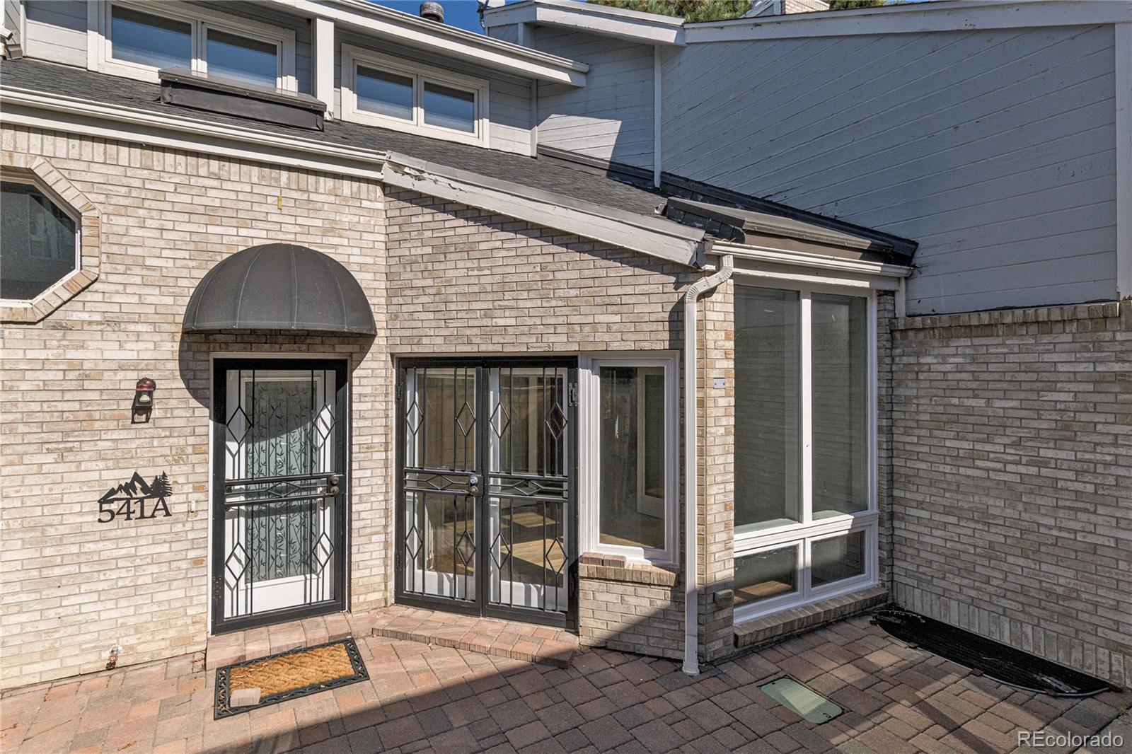 541 Monroe Street, Unit A Denver, CO 80206 - Photo 38 of 45 a view of a brick house with entryway