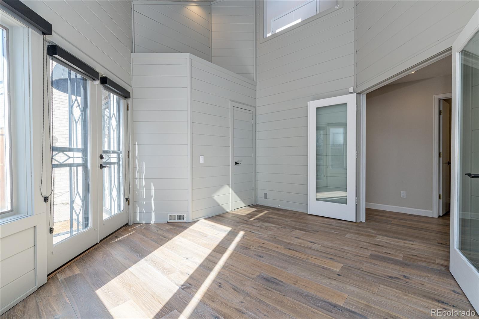 541 Monroe Street, Unit A Denver, CO 80206 - Photo 4 of 45 a bedroom with a bed and wooden floor