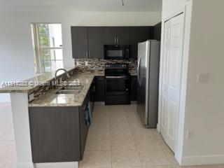 West Kendall Miami, FL 33193 - Photo 3 of 20 a kitchen with granite countertop a refrigerator stove and microwave