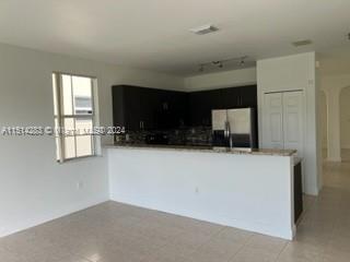 West Kendall Miami, FL 33193 - Photo 4 of 20 a living room with a couch and a flat screen tv