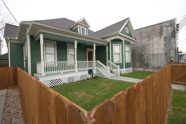 a view of a house with wooden floor and a small yard