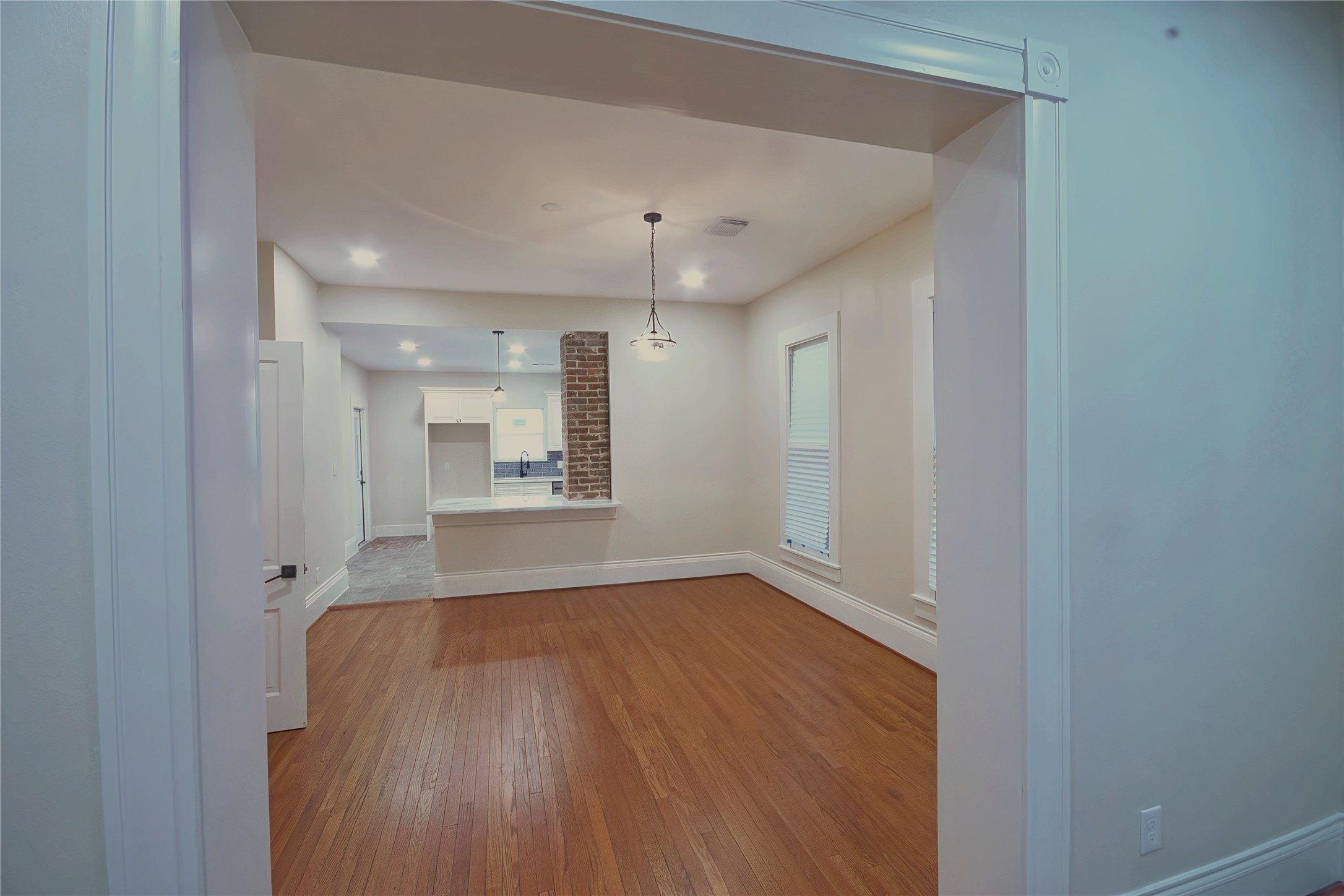 505 Winnie Street Houston, TX 77009 - Photo 7 of 29 View from the living room into the dining room and kitchen