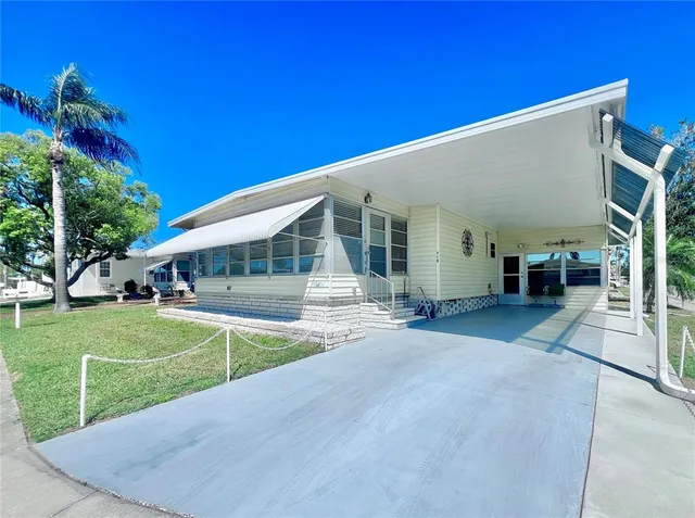a view of a house with a swimming pool and sitting area