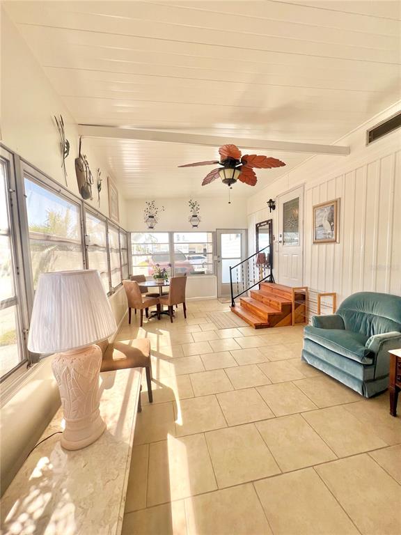 1100 South Belcher Road, Unit 719 Largo, FL 33771 - Photo 13 of 60 a living room with couches and kitchen view with wooden floor