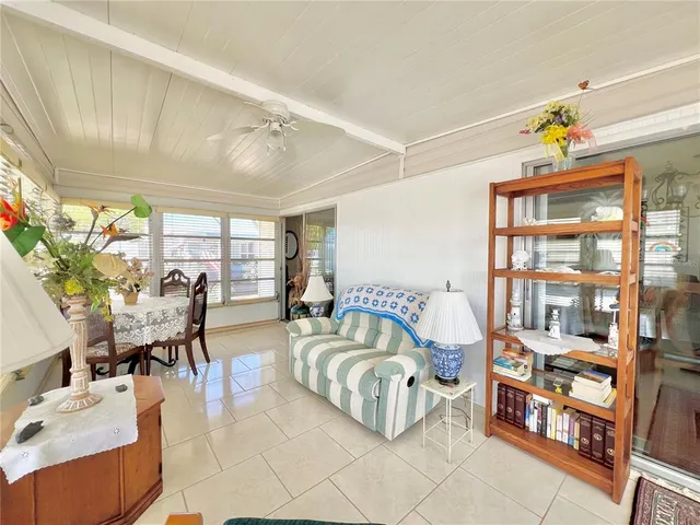 a living room with furniture a window and wooden floor